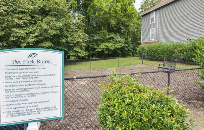 a dog park with a sign that says pet park rules at Canopy at Baybrook apartments in Charlotte NC