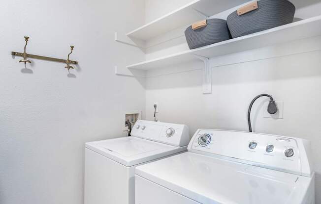 A white laundry room with a washer and dryer.