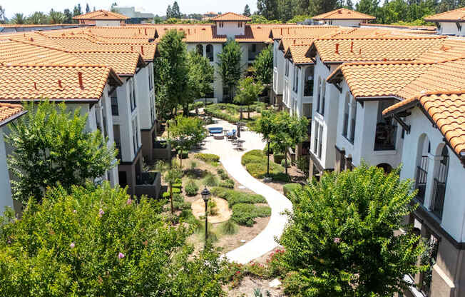 A view of a courtyard surrounded by buildings with red roofs.