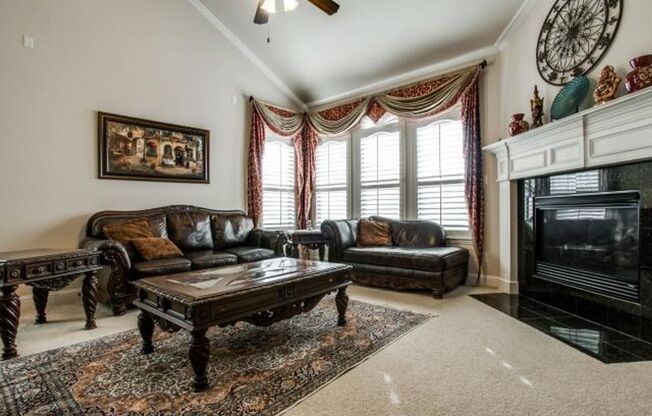 Bright and airy living room, fireplace, study, custom lighting in the formal living and dining.