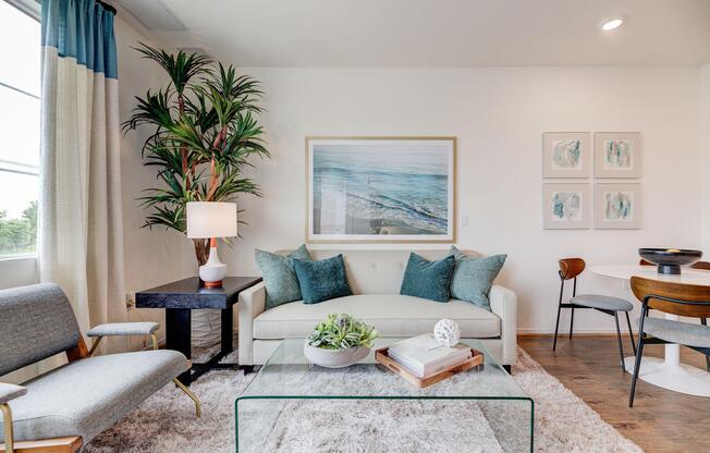 a living room filled with furniture and a large window