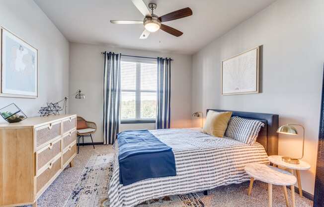 a bedroom with a bed and a ceiling fan