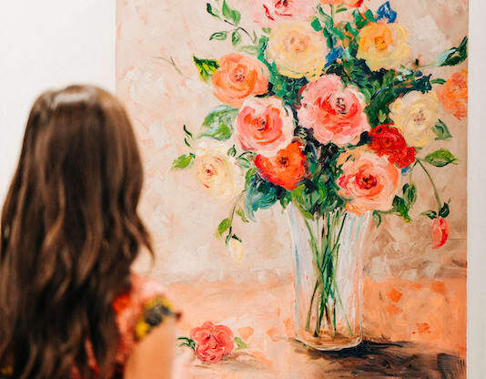 Girl admiring a beautiful rose painting at The Roseberry, Columbia, South Carolina