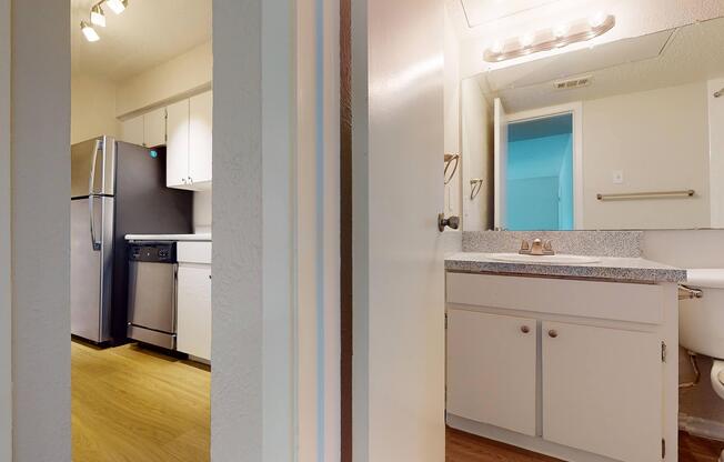 a kitchen with a sink and a mirror