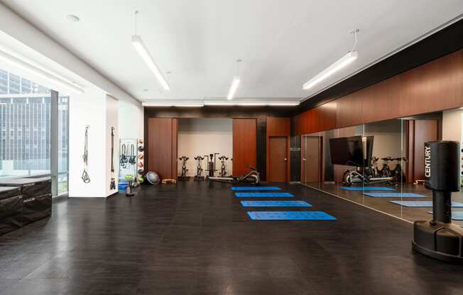 a workout room with weights and cardio equipment in a large room