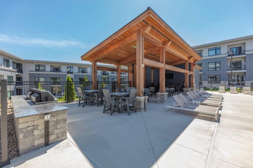 a covered patio with tables and chairs and a fire pit at Two Points Crossing, Verona, Wisconsin, 53593