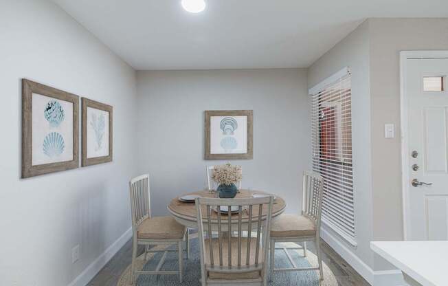 A dining room with a table set for four.