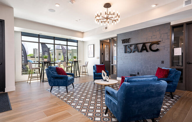 a living room with blue couches and chairs and a chandelier