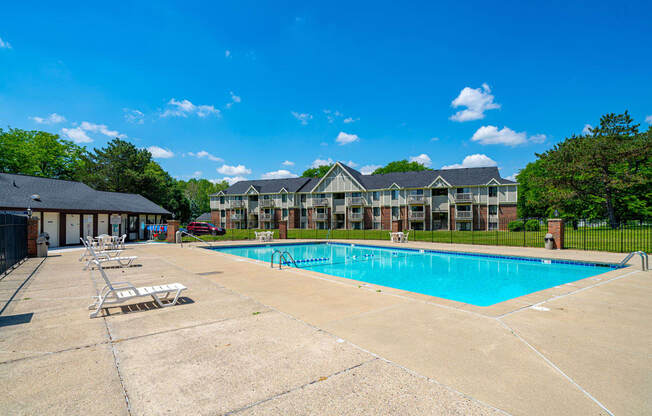 Lounge Chairs on Sundeck by Large Pool at Waverly Park Apartments, Lansing