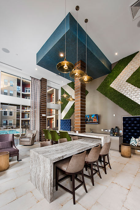 a large living room with a table and chairs