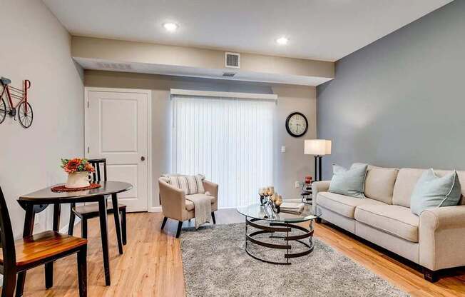 a living room with a couch and a table. Circle Pines, MN Lexington Lofts