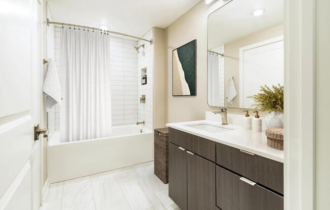 A bright, streamlined bath at Modera Parkside in Atlanta features clean tilework and polished finishes, with easy access to Midtown and nearby green spaces.