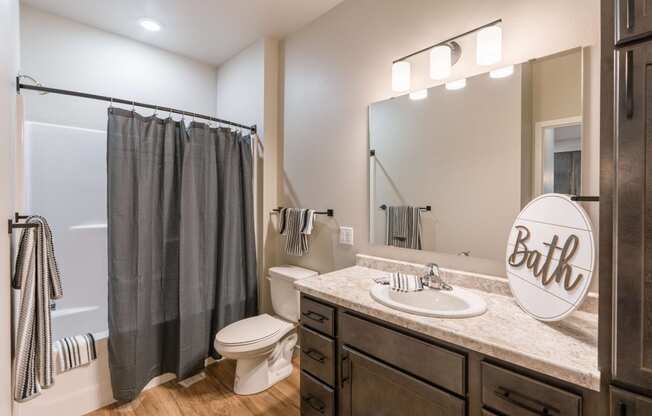 the private bathroom of a home with a shower toilet and sink. Fargo, ND Prairiewood Meadows | LivingFargo, ND Prairiewood Meadows