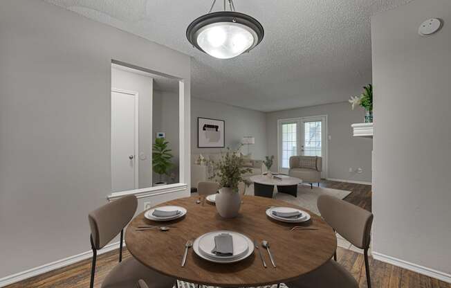 A dining room with a table set for two.
