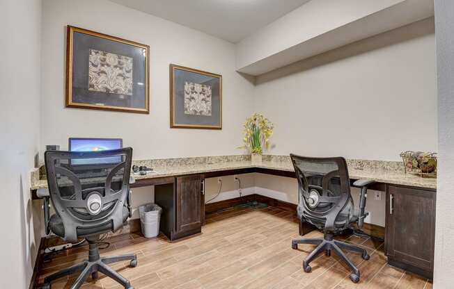 a home office with two desks and two chairs