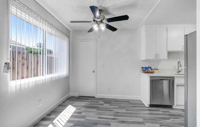 a kitchen with a ceiling fan and a window