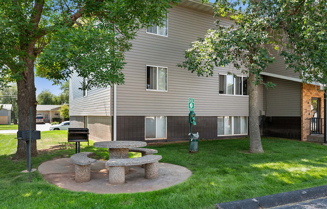 a stone picnic table in the yard of an apartment building
