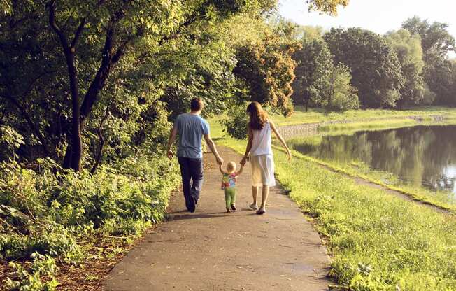 a family walking down a path with a child