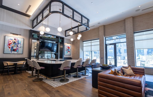 the lobby of a hotel with a bar and a staircase in the ceiling