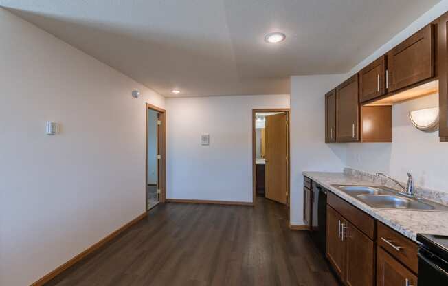 a dining room with a door to a bedroom and bathroom in the background. Fargo, ND Westwood Apartments