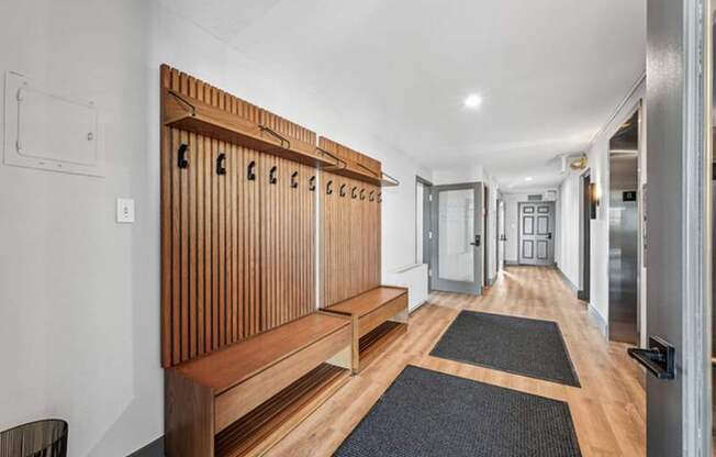A long hallway with a bench and a door at the end.