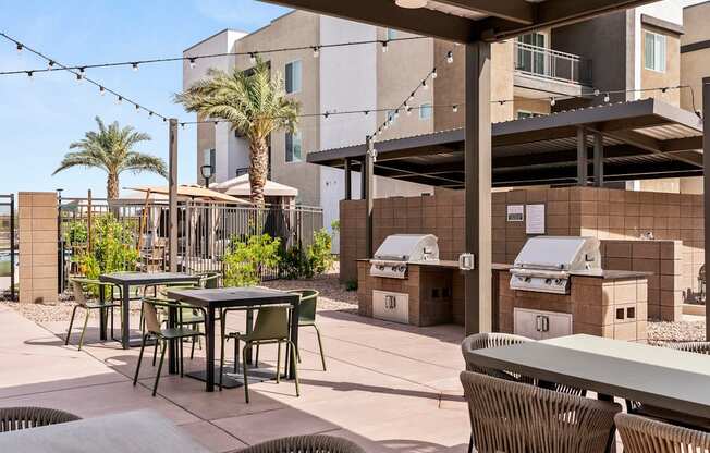 A patio with a table and chairs under a roof.