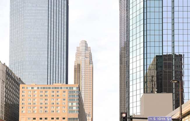 A city street with a tall building on the left and a taller one on the right.