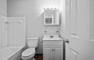 a bathroom with a sink toilet and a bath tub