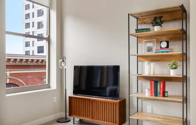 a living room with a couch and a television and a bookshelf