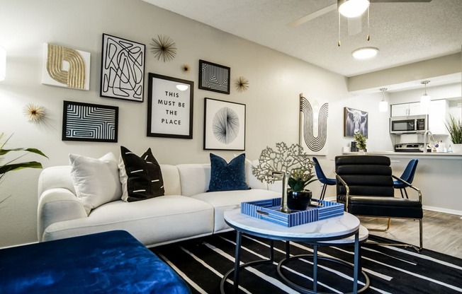 an open living room with a white couch and a coffee table