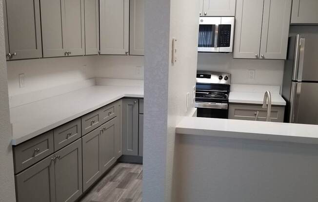 2x1 kitchen with white countertop and grey cabinets.