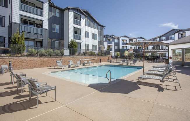 Pool on sunny day with lounge chairs