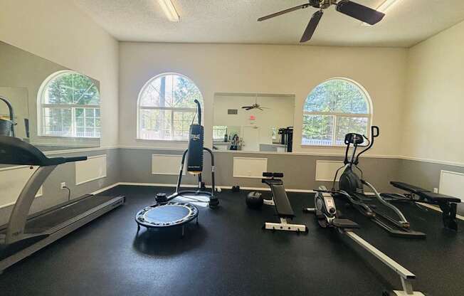 A spacious home gym with a treadmill, elliptical trainer, and other exercise equipment.