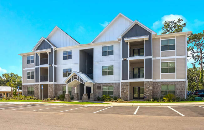 a large apartment building with a parking lot in front of it