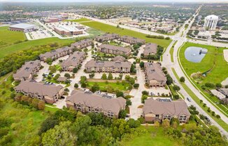 a neighborhood of houses on a grassy field