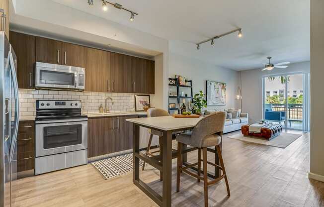 an open kitchen and living room with a table and chairs