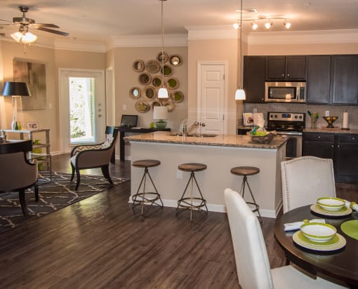 an open kitchen and living room with a dining room table and chairs at Echo at Lake Norman, Mooresville