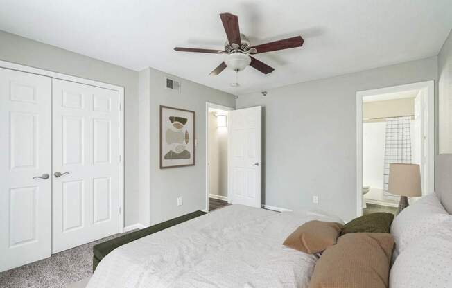 a bedroom with a large bed and a ceiling fan