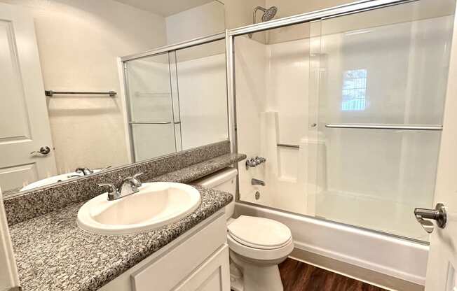 an empty bathroom with a sink toilet and shower