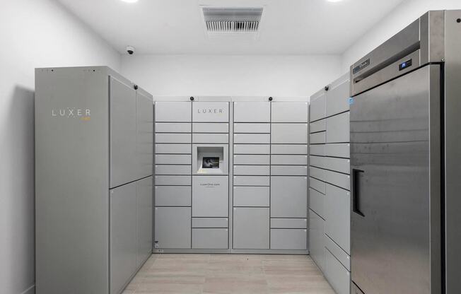 The laundry room has stainless steel appliances and white walls