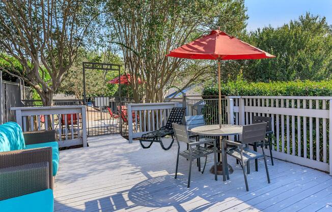 a group of lawn chairs sitting on top of a wooden fence