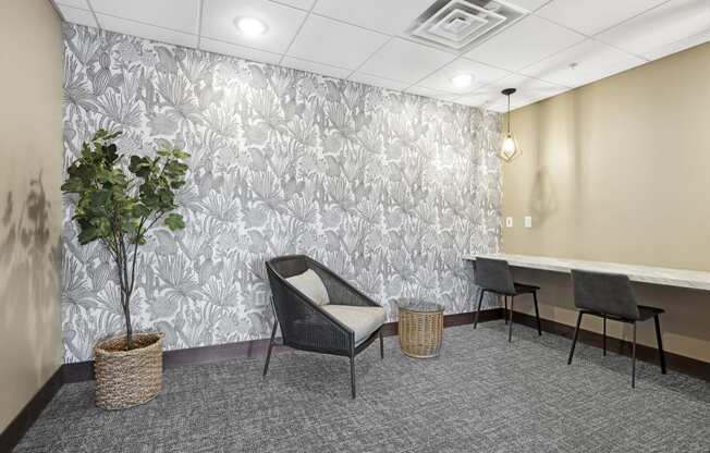 a seating area with a plant and three chairs