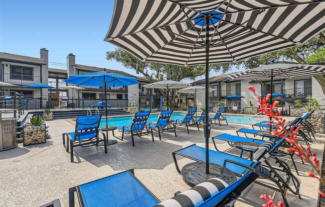 our patio is full of chairs and umbrellas and a pool