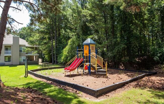 the playground is in the middle of a yard with a slide