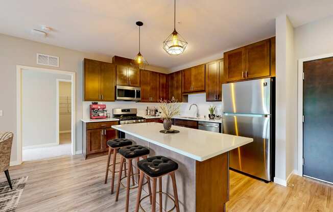 a kitchen with a large island with three stools