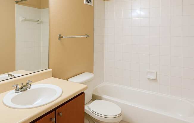 A bathroom with a toilet, sink, and bathtub.