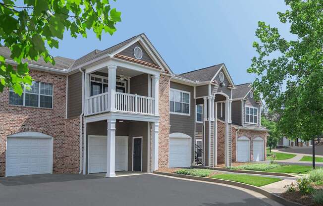 A two-story house with a balcony on the second floor.