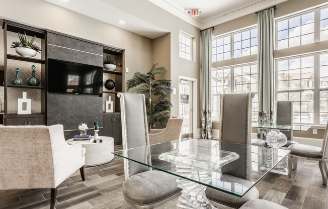 a living room with a glass table and chairs