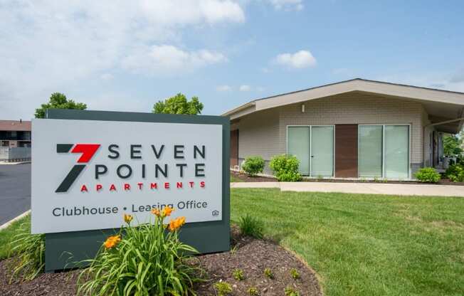 a building with a 7 seven pointe apartments sign in front of it