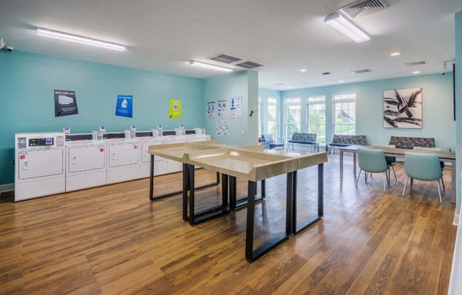 a communal room with a table and chairs and laundry facilities